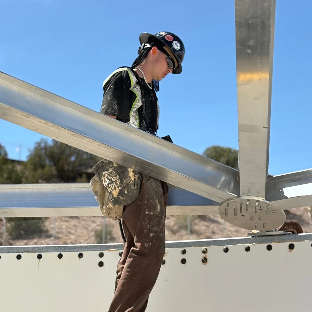 Seamus Miller performing hands-on field work during bolted steel tank assembly