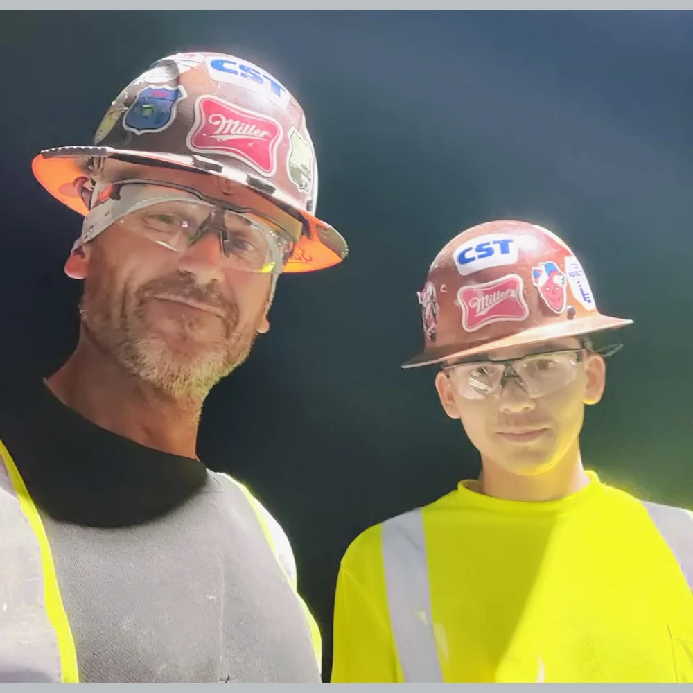 Jason and Seamus Miller together in work gear and hard hats